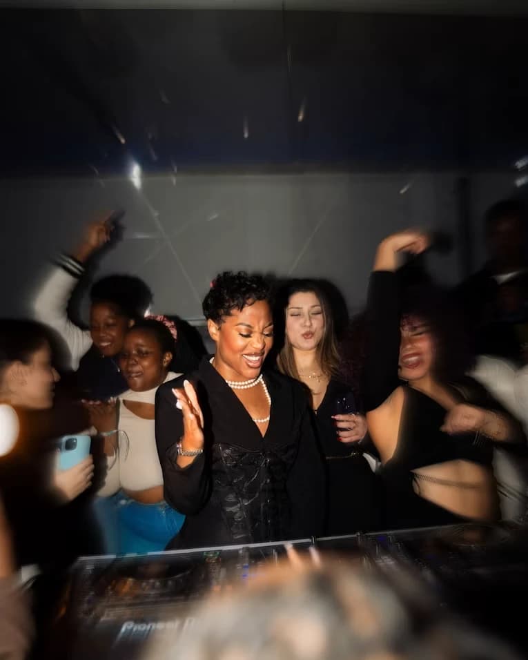 Someone working the decks with the floor dancing behind them
